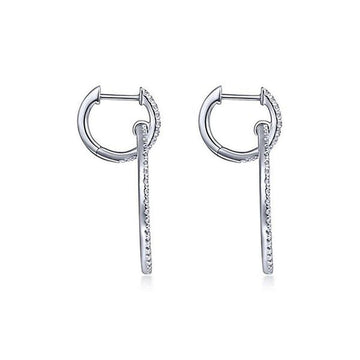 Diamond huggie earrings with dangling diamond accents.
