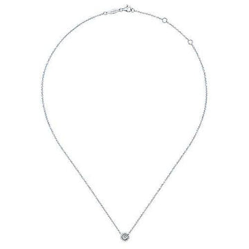 Dainty diamond pendant necklace on a delicate chain.
