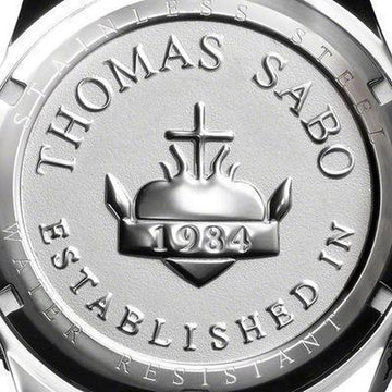 Close-up of watch back, showcasing embossed logo and "Established 1984" detail.
