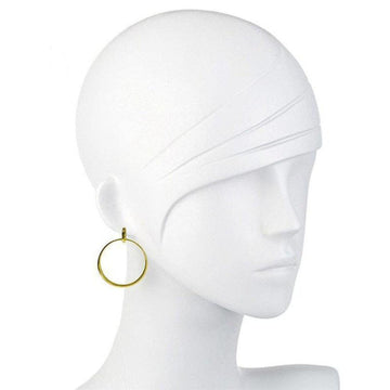 Gold drop hoop earrings on a mannequin.

