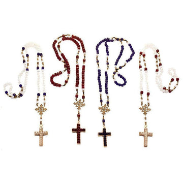 Four beaded rosaries with ornate crosses; red, white, blue, and clear glass beads.

