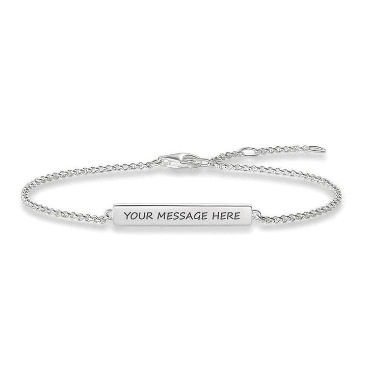 Engravable silver bar bracelet with delicate chain, personalized message.
