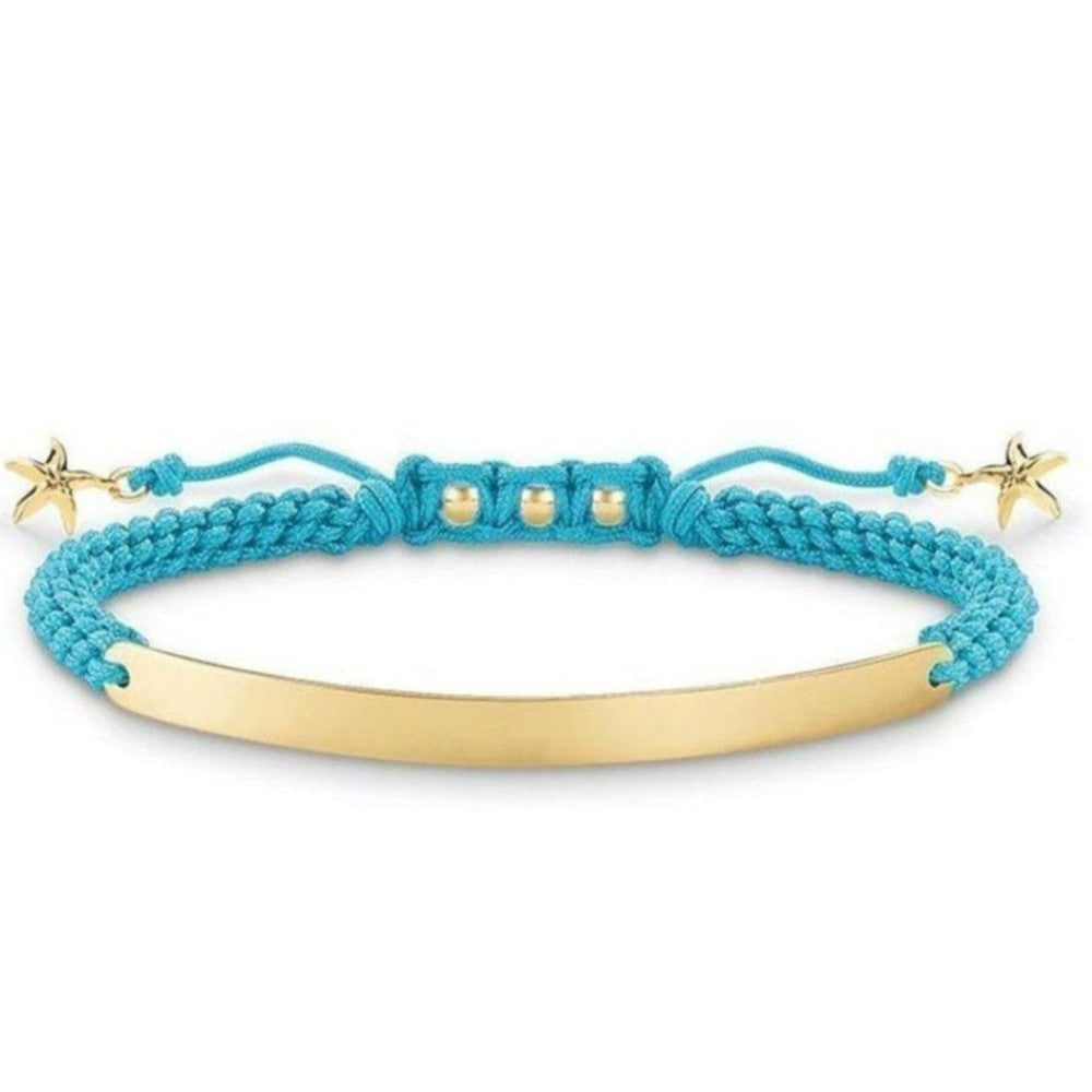 Engravable turquoise braided bracelet with gold bar & starfish charms.
