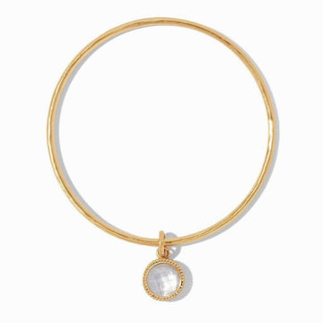 Gold bangle bracelet with a delicate, faceted opal charm.
