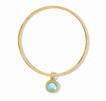 Gold Fleur-de-Lis bangle with light blue gemstone charm
