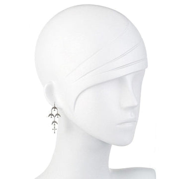 Silver bird and cross dangle earrings on mannequin.
