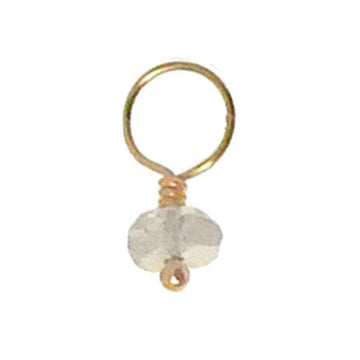 Gold wire accent with a small, faceted gemstone pendant.
