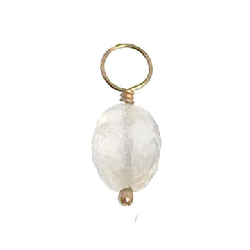 White gemstone charm with gold wire and loop.
