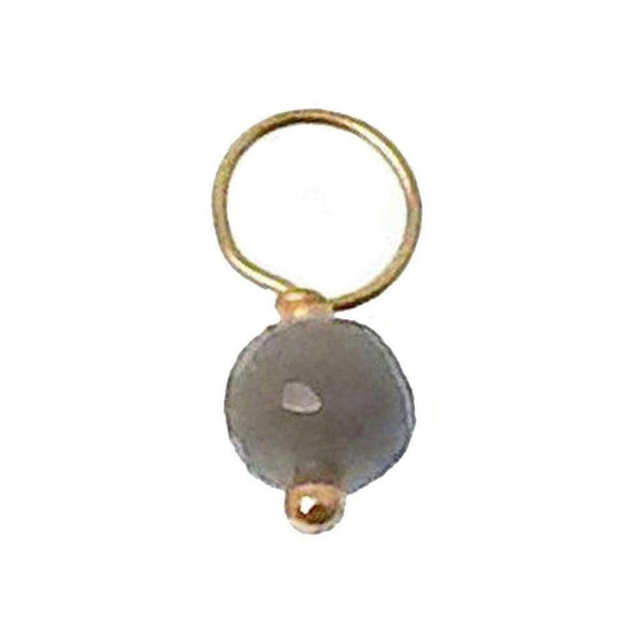 Gray gemstone pendant with gold accents and loop.
