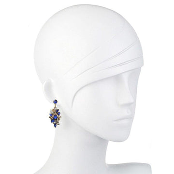 Dazzling blue and clear crystal drop earrings on a mannequin.
