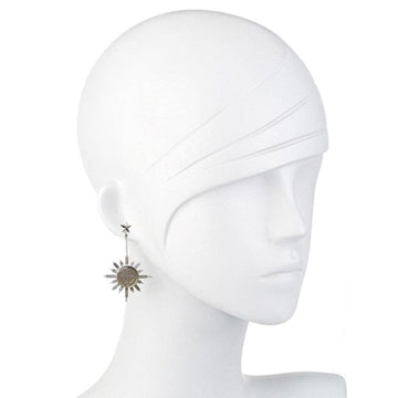Silver sunburst earrings with star accents, displayed on a mannequin.
