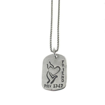 Silver "God Tag Friend" necklace featuring heart & hands design, "Friend" inscription, and Prov 17:17.
