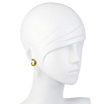 Gold hoop earrings on a mannequin.
