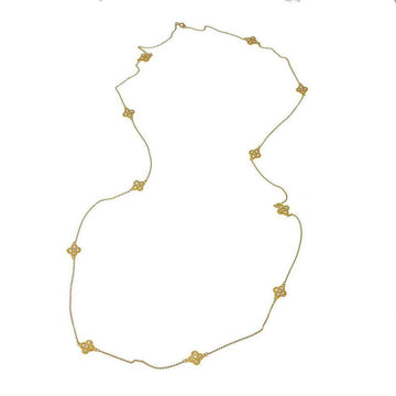 Long gold necklace with delicate clover accents and small sparkling stones.
