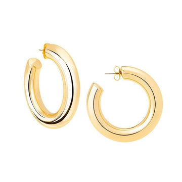 Gold medium hoop earrings; bold statement jewelry.
