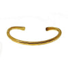 Hammered gold cuff bracelet with textured finish.
