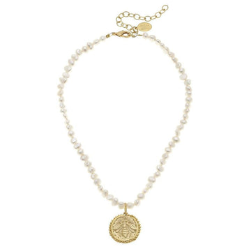Gold bee pendant necklace with creamy pearl accents.
