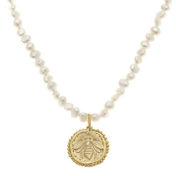 Handcast gold bee pearl necklace featuring a textured gold bee charm.
