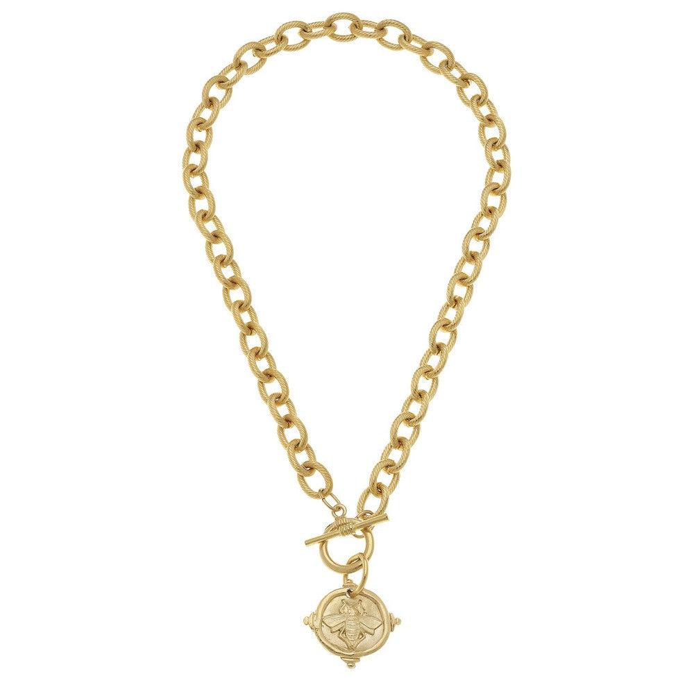 Gold chain necklace featuring a bee medallion pendant.
