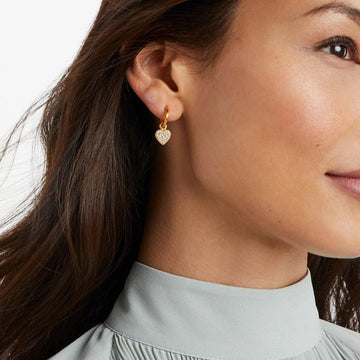 Gold hoop earrings with a sparkling pave heart charm.
