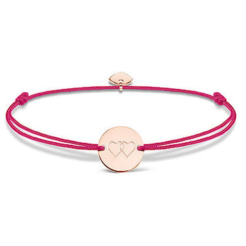 Rose gold heart medallion bracelet on a pink cord.
