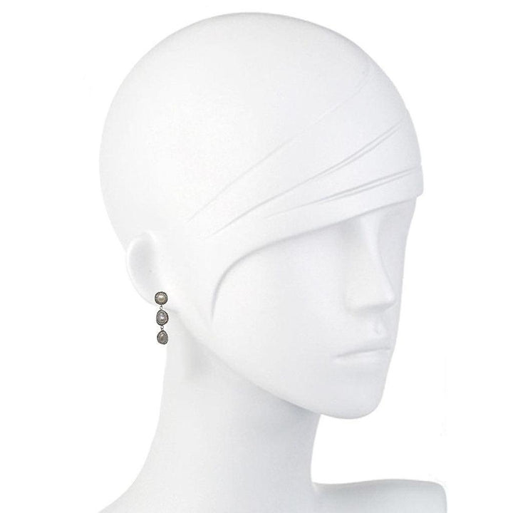 Hematite gemstone drop earrings on a mannequin, showcasing their elegant design.
