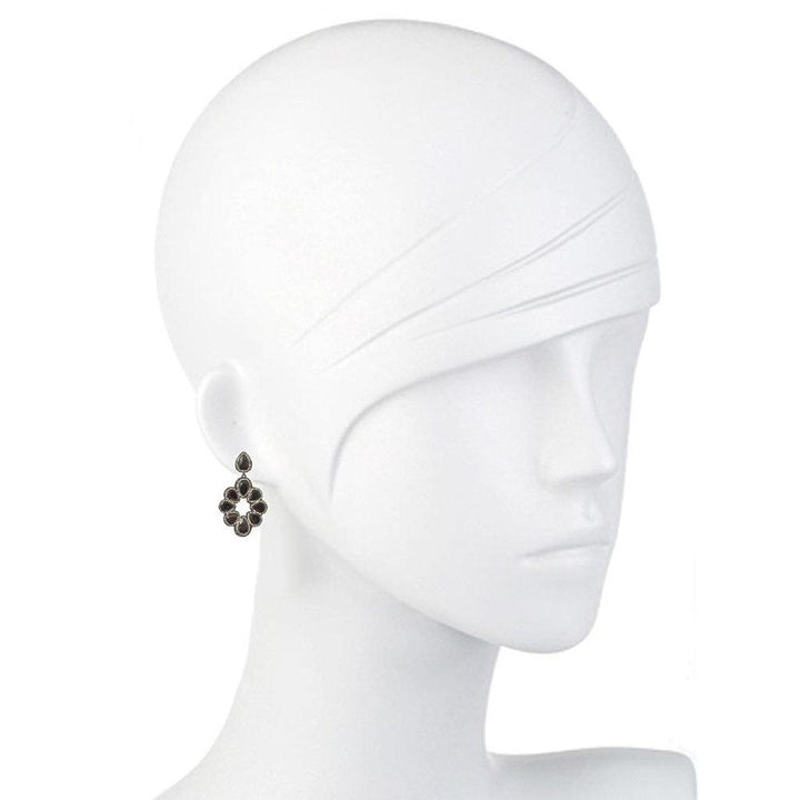 Dark gray hematite and crystal drop earrings on a mannequin.
