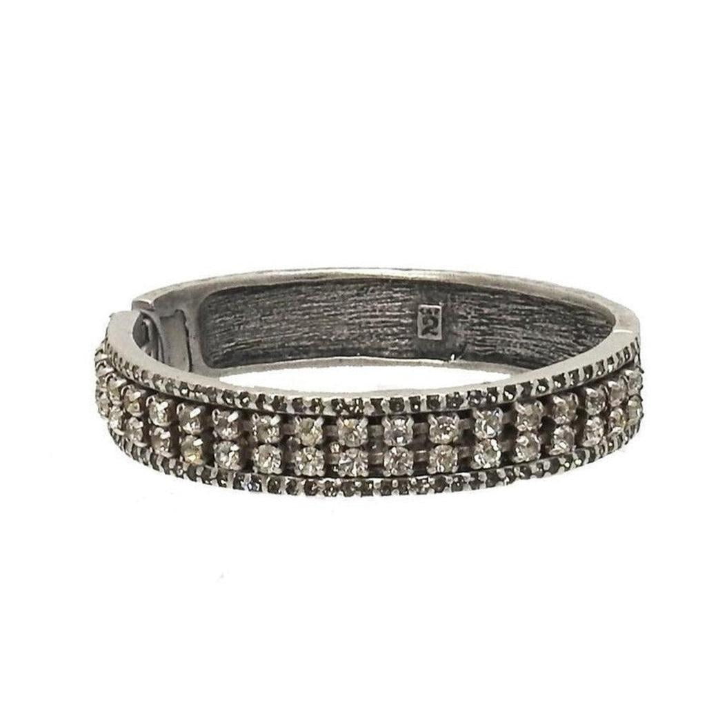 Silver hinged bangle bracelet with crystal detailing.
