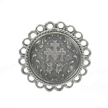 Silver ring featuring an ornate circular design, centered with a religious medallion.
