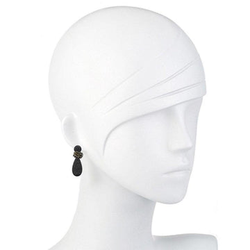 Black teardrop earrings with beaded detail on a mannequin.
