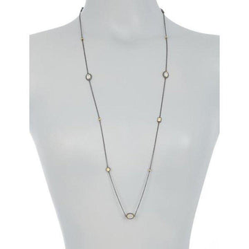 Long mother-of-pearl station necklace with dark metal chain and gold accents.
