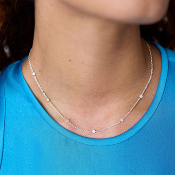 Celeste silver station necklace featuring delicate bezel-set cubic zirconia crystals on a slender chain.