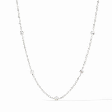 Celeste silver station necklace featuring delicate chain links and round bezel-set cubic zirconia crystals.