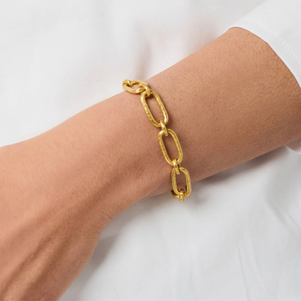 Gold-plated Sahara Demi link bracelet with a textured chain design worn on a wrist against a white background.