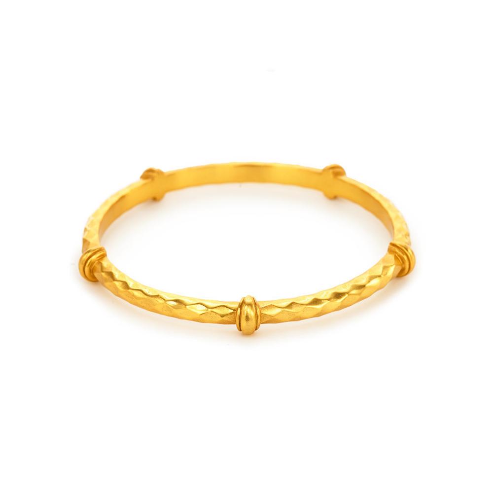 Medium Savannah stacking bangle in 24K gold plate with a textured hammered design and smooth accent beads.