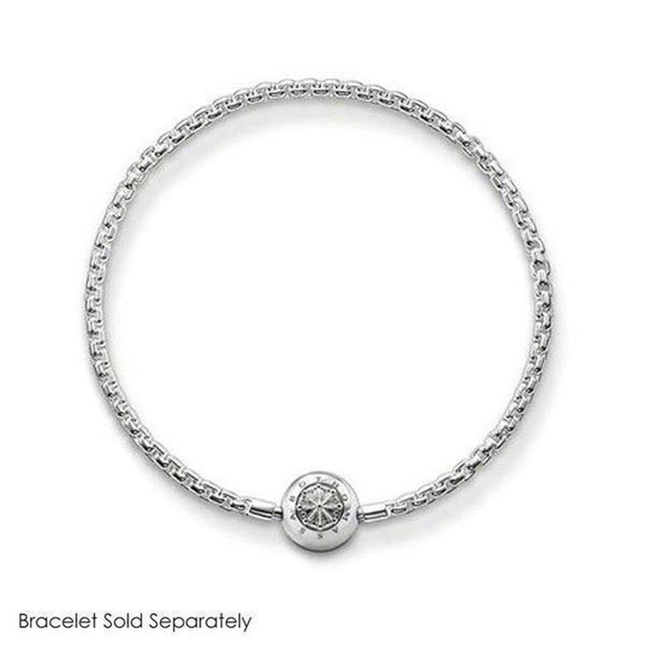 Silver charm featuring an engraved circular design, shown on a delicate chain bracelet (sold separately).
