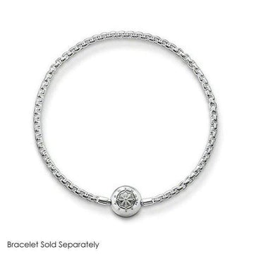 Silver charm featuring an ornate, circular design, shown on a silver chain bracelet (bracelet sold separately).
