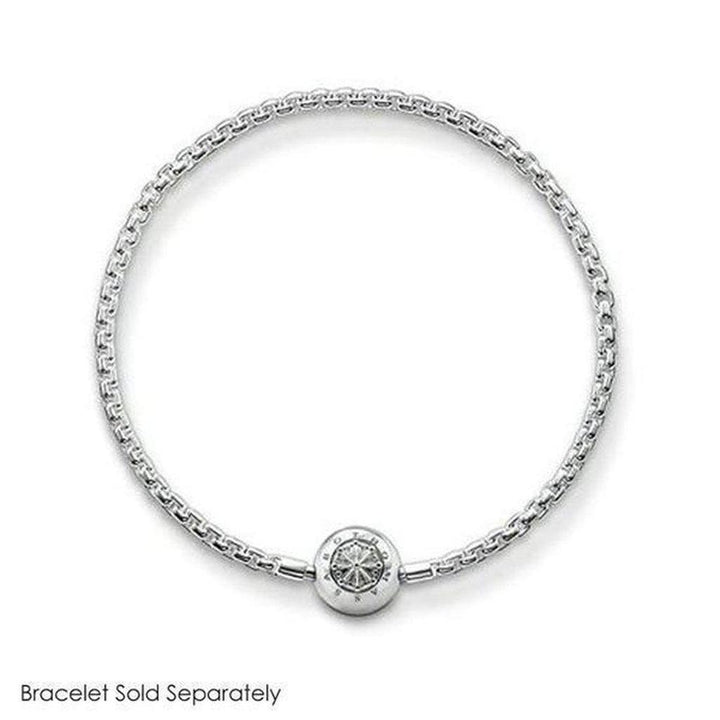 Silver charm featuring an ornate, circular design, shown on a silver chain bracelet (bracelet sold separately).
