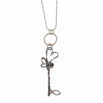 Silver key necklace with intertwined hearts, delicate chain.

