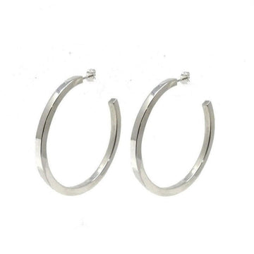 Silver large hoop earrings; modern, minimalist design.
