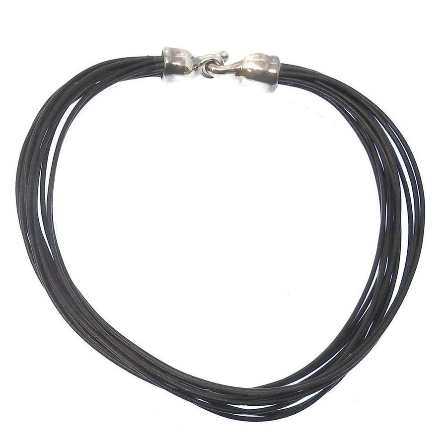 Multi-strand black leather necklace with silver clasp.
