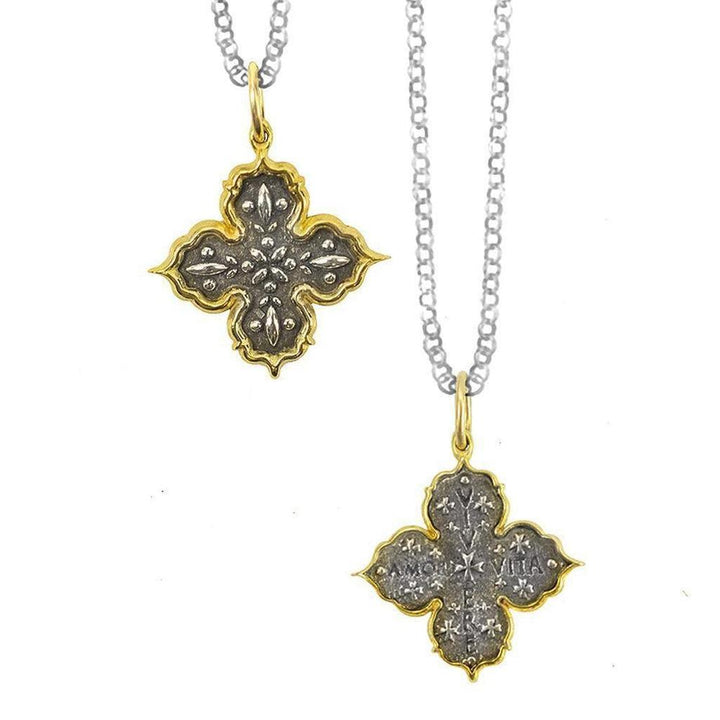 Live, Love, Life Charm Necklace: Two-tone silver and gold cross pendant with intricate detailing on a delicate chain.
