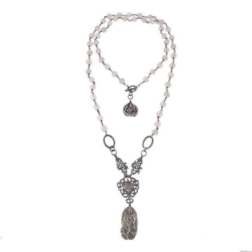 Double-strand beaded necklace with ornate silver pendant; features a heart charm and detailed medallion.
