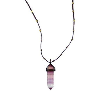 Love Heals Nico Fluorite Pendant: Purple, layered fluorite point on a dark cord necklace with gold accents.
