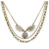 Lulu Frost Heirloom Sunburst necklace: antique gold layered chain with sparkling crystal sunburst pendant.
