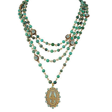 Multi-strand turquoise bead necklace with gold accents and Virgin Mary pendant.
