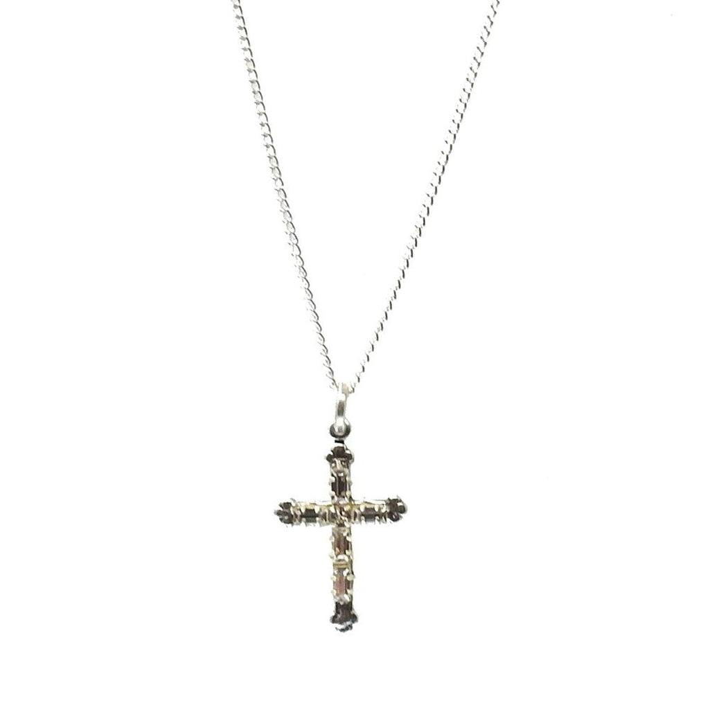 Silver cross pendant necklace with sparkling stones.
