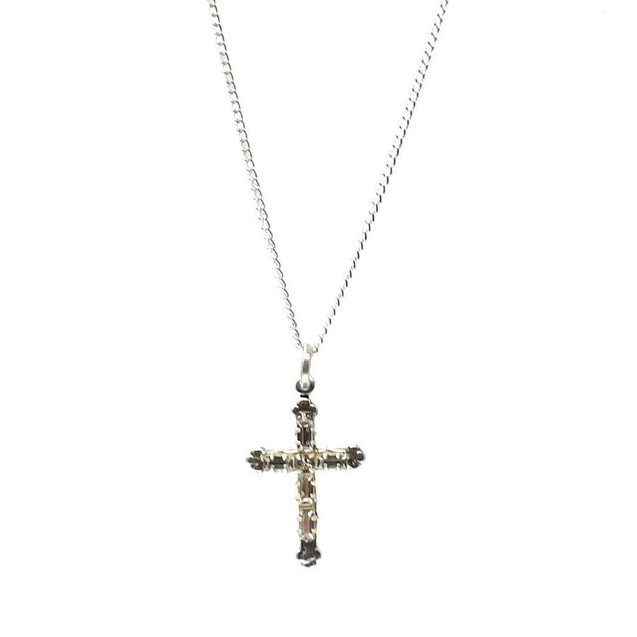 Silver cross pendant necklace with sparkling stones.
