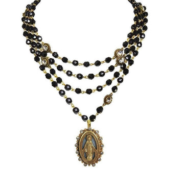 Multi-strand black bead necklace with gold accents and Virgin Mary pendant.
