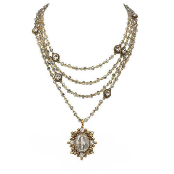Multi-strand necklace with gold accents and crystal beads, featuring an ornate pendant.
